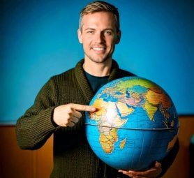 Firefly A picture of a man holding the globe and pointing to all the countries, which conveys the co (1)